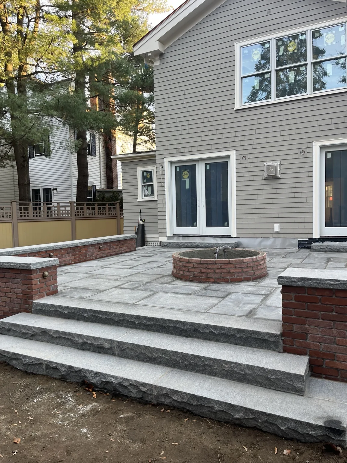 Finished bluestone patio and brick wall