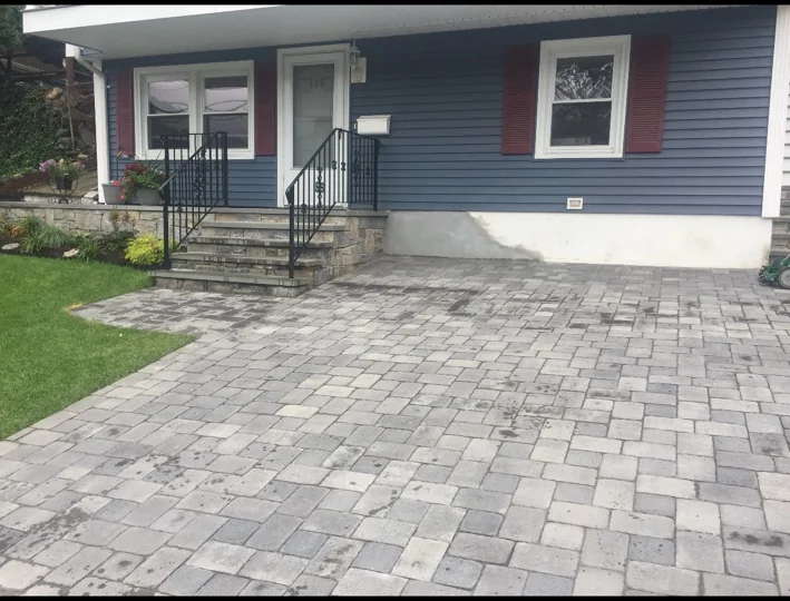 Finished paver patio by blue house
